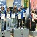Na zdjęciu zawodniczki HKS Azymut Mochy stojące na podium zajmując 1 i 2 miejsca. Pozują z medalami, dyplomami. Obok nich na miejscu 3 stoją zawodniczki z innego klubu.