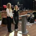 Na zdjęciu dwójka uczennic klasy pierwszej przemawiają podczas uroczystości.