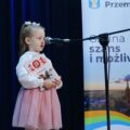 Dziewczynka śpiewa na scenie.
