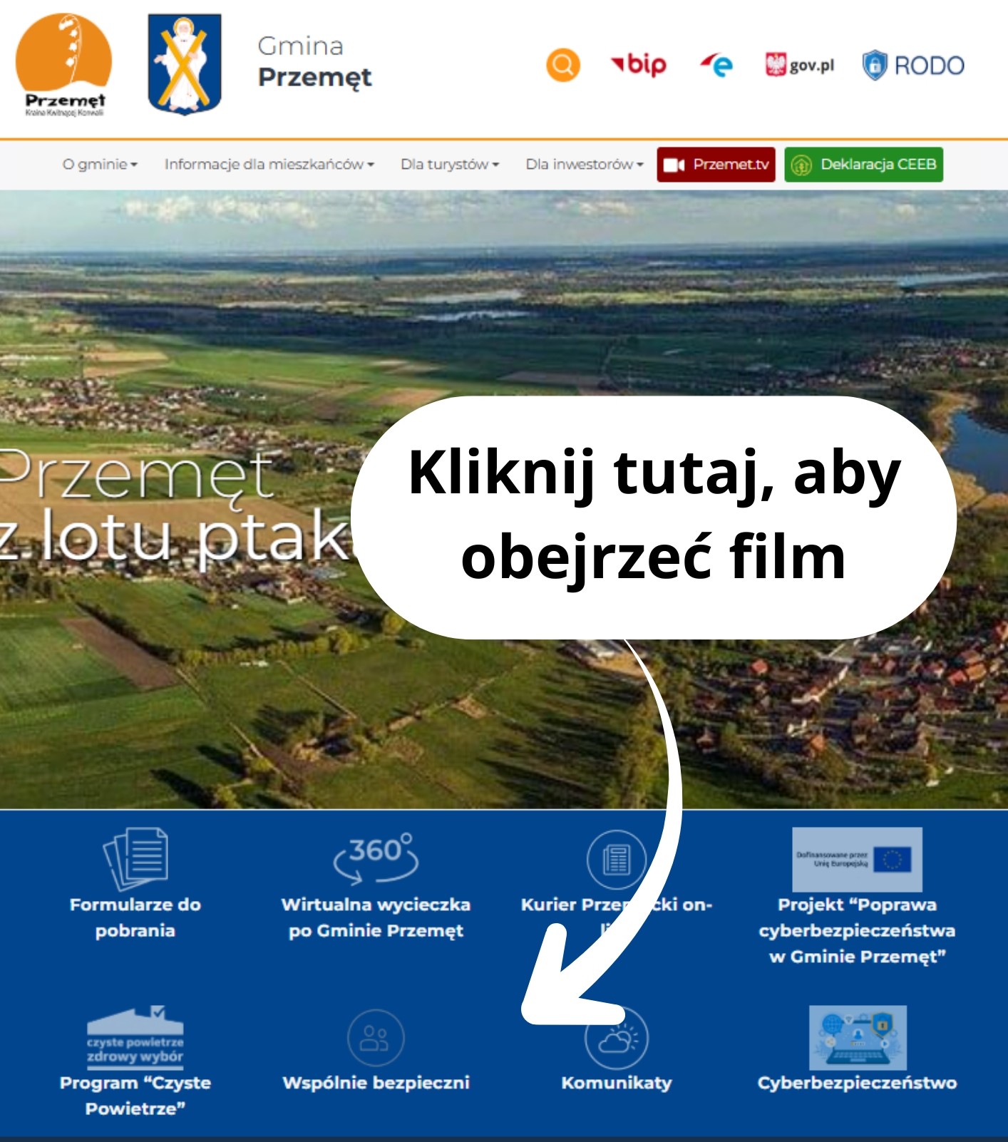 Grafika przedstawia screenshot strony internetowej Gminy Przemęt. Biała strzałka wskazuje na widoczną na stronie kategorie "Wspólnie bezpieczni". Przy strzałce dodano napis: "Kliknij tutaj aby obejrzeć film".