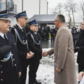 Na fotografii widoczny wójt, który składa druhom gratulacje.