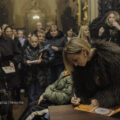 Na fotografii widoczna piosenkarka, która rozdaje ludziom autografy.