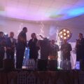 Na zdjęciu widoczny wójt, dyrektor przedszkola oraz inne osoby. Dyrektor składa wójtowi podziękowania.